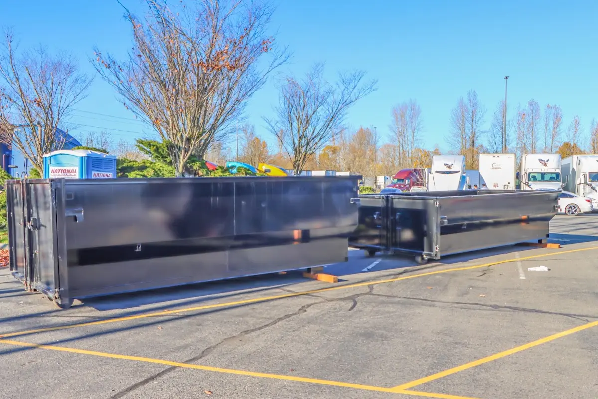 Professional dumpster rental service with roll-off container on residential driveway in Trotwood